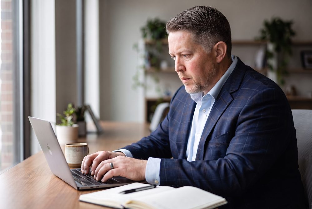Andrew Kokes writing at his desk